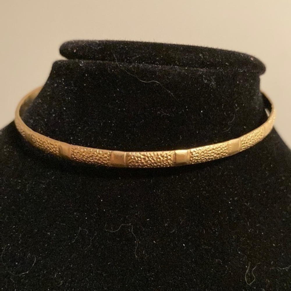 Golden bangle bracelet.
